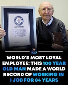 An elderly man displaying his Guinness World Record certificate for 84 years of employment, a testament to his resilience and endurance in the workplace.